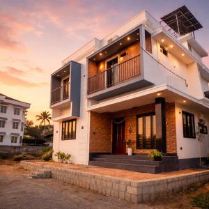 a large white house with a sunset in the background at Nana's Residency, Cochin in Alwaye
