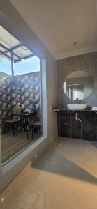a bathroom with a sink and a mirror and a table at TEBiNG Guest House Taman Negara Malaysia Kuala Tahan in Kuala Tahan +62 photos