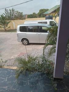 a white van parked in a parking lot at Luxury Live Inn Suite in Owuraman
