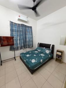 a bedroom with a bed and a ceiling fan at ZARA Homestay in Marang