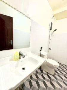 a white bathroom with a sink and a toilet at RV3 TRANSIENT HOUSE in Angeles +26 photos