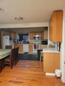 a kitchen with wooden cabinets and a table with chairs at Nice and cozy in Bremerton