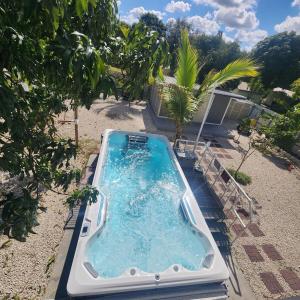 a hot tub in the backyard of a house at Private and beautiful room for vacation in Carver Ranches +2 photos