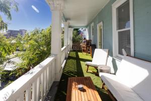 a porch with a table and chairs on a house at Church GTX in Galveston