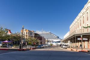 an empty street with a cruise ship in the background at Church GTX in Galveston