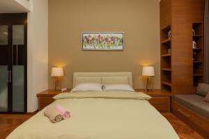 a bedroom with a bed with two pillows on it at SQSu in Tanjong Tokong +2 photos