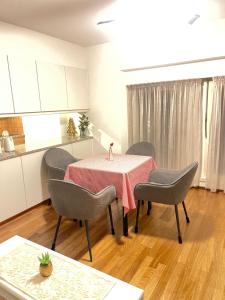 a dining room with a table and chairs in a kitchen at Rivellino Guesthouse app 1 in Locarno