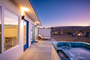 a bathroom with a hot tub in a house at Santorini with Stargazing - Views - Spa - Fire pit in Yucca Valley