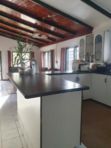 a kitchen with a large island in a room at Stay with Sheena - Homestay Experience in Nadi