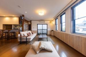 a living room with a couch and a table at Tabiudo Souwa in Takayama