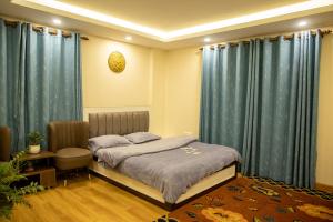 a bedroom with a bed and blue drapes at Zen Space in Kathmandu