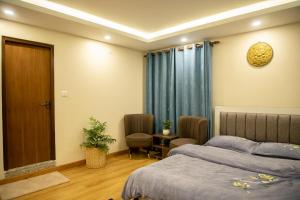 a bedroom with two beds and a table and chairs at Zen Space in Kathmandu