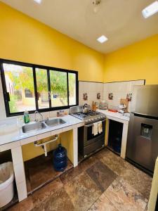 a kitchen with a sink and a stove at Bungalows Las Palmas Cabo Pulmo in Cabo Pulmo