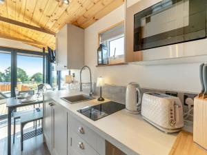 a kitchen with a sink and a counter at Barn Owl Lodge - Uk49903 in Appley Bridge