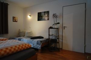 a bedroom with two beds and a door to a room at Ferienwohnung Schog in Todtnau