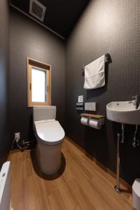 a bathroom with a toilet and a sink at Tsuzumi Suite - Private Cinema & Immersive Stay in Kanazawa in Housai +54 photos