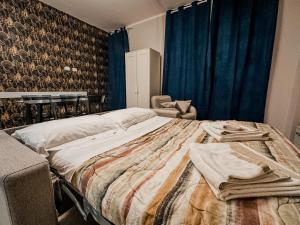 a bedroom with a large bed and a chair at Velvet Suite - Garage Privato - Metro Dante in Turin
