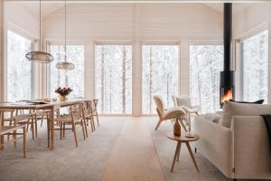 a dining room and living room with a table and chairs at Arctic Design Villa Levi in Levi
