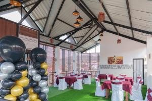 a banquet hall with tables and balloons in a room at St Anthonys Holiday Inn in Kotagala