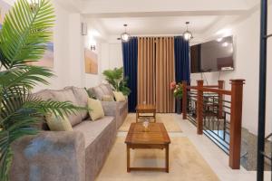 a living room with a couch and a table at St Anthonys Holiday Inn in Kotagala