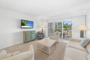 a living room with a couch and a table at Beach Villas 2514 condo in Captiva