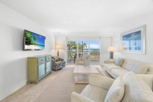 a living room with a couch and a tv at Beach Villas 2514 condo in Captiva