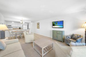 a living room with a couch and a table at Beach Villas 2514 condo in Captiva