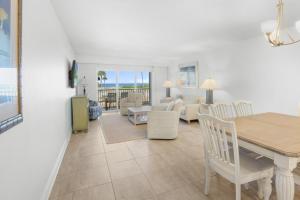 a dining room and living room with a table and chairs at Beach Villas 2514 condo in Captiva +16 photos