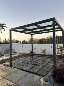 a pergola on top of a patio at AA villa in Calodyne