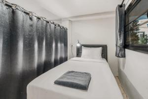 a bedroom with a bed with a black curtain at Chill Inn Hub in Lamai +35 photos