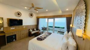 a hotel room with a bed and a large window at Solaluna Beach Homestay in Amed