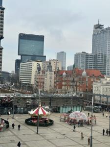 a group of people walking around a city with buildings at LivingRoom 3 Family Self Check-in 24h in Katowice