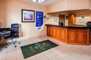a waiting room with a desk and a chair at Quality Inn Tomah in Tomah +9 photos
