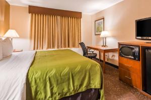 a hotel room with a bed and a television at Quality Inn Tomah in Tomah