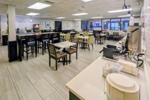 an empty restaurant with tables and chairs and tablesktop at Quality Inn Warrensburg in Warrensburg