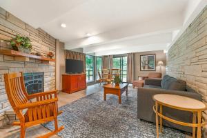 a living room with a couch and a fireplace at Fairway Inn and Suites, an Ascend Collection Hotel in Mishicot