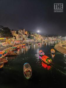 a group of boats in a river at night at The Gripa Hotels in Chitrakoot