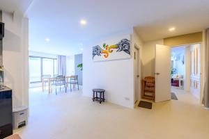 a living room with white walls and a table and chairs at Mountain View Escape at Primrose Hill in Bangrak Beach
