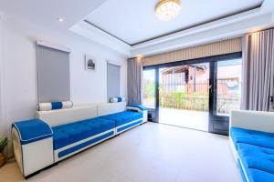 a living room with a blue and white couch at Mountain View Escape at Primrose Hill in Bangrak Beach