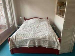 a bedroom with a bed with a blanket on it at Studio 11 in Utrecht