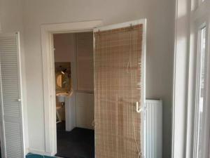 a bathroom with a shower with a tile wall at Studio 11 in Utrecht