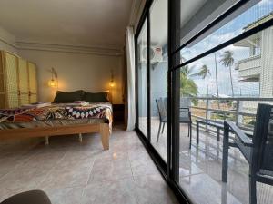 a bedroom with a bed with a view of the ocean at Nest by Aerial Lanta in Ko Lanta