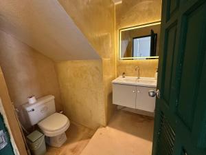 a small bathroom with a toilet and a sink at Nest by Aerial Lanta in Ko Lanta +14 photos