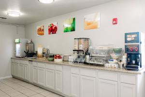 a kitchen with a counter with some food on it at Quality Inn & Suites Lathrop in Lathrop