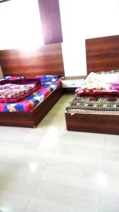 two beds sitting next to each other in a room at Hotel Venkatesh in Badrinath