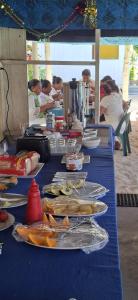 a long blue table with plates of food on it at DO NOT USE this in Apia