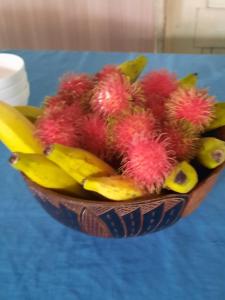 a bowl of fruits and bananas on a table at DO NOT USE this in Apia