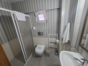 a small bathroom with a toilet and a sink at Gizem Pansiyon in Çanakkale +52 photos