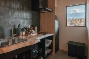 a kitchen with a sink and a refrigerator at なか富士 -Nakafuji- in Fujinomiya +98 photos