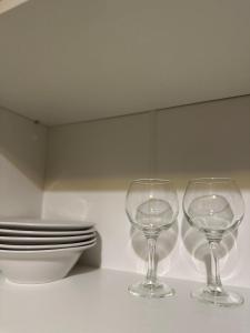 two wine glasses sitting on top of a counter at Квартира на Перемоги in Lutsk